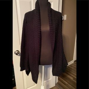 Chunky black cardigan sweater with pockets.